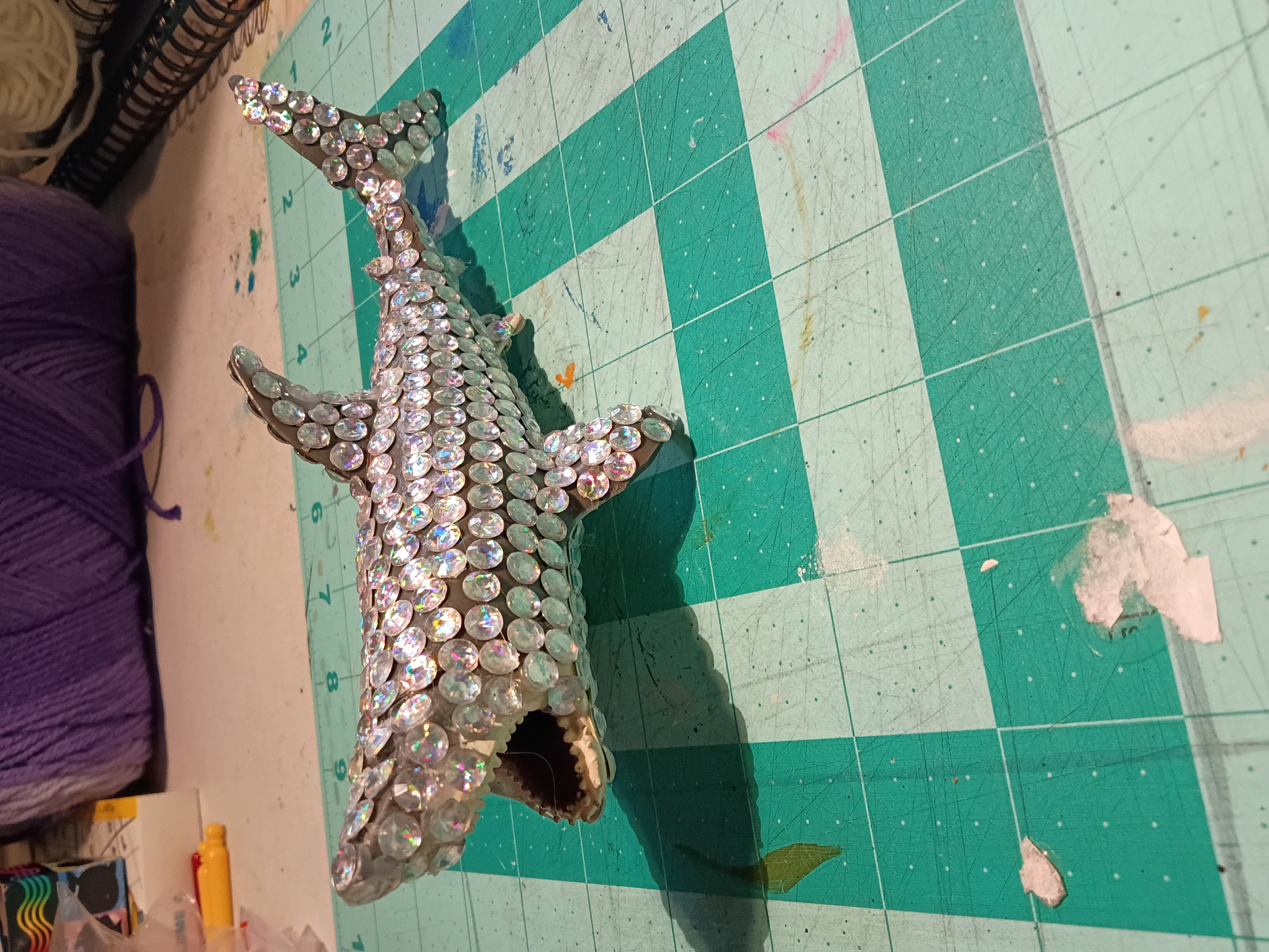 a grey shark figurine covered in plastic gems