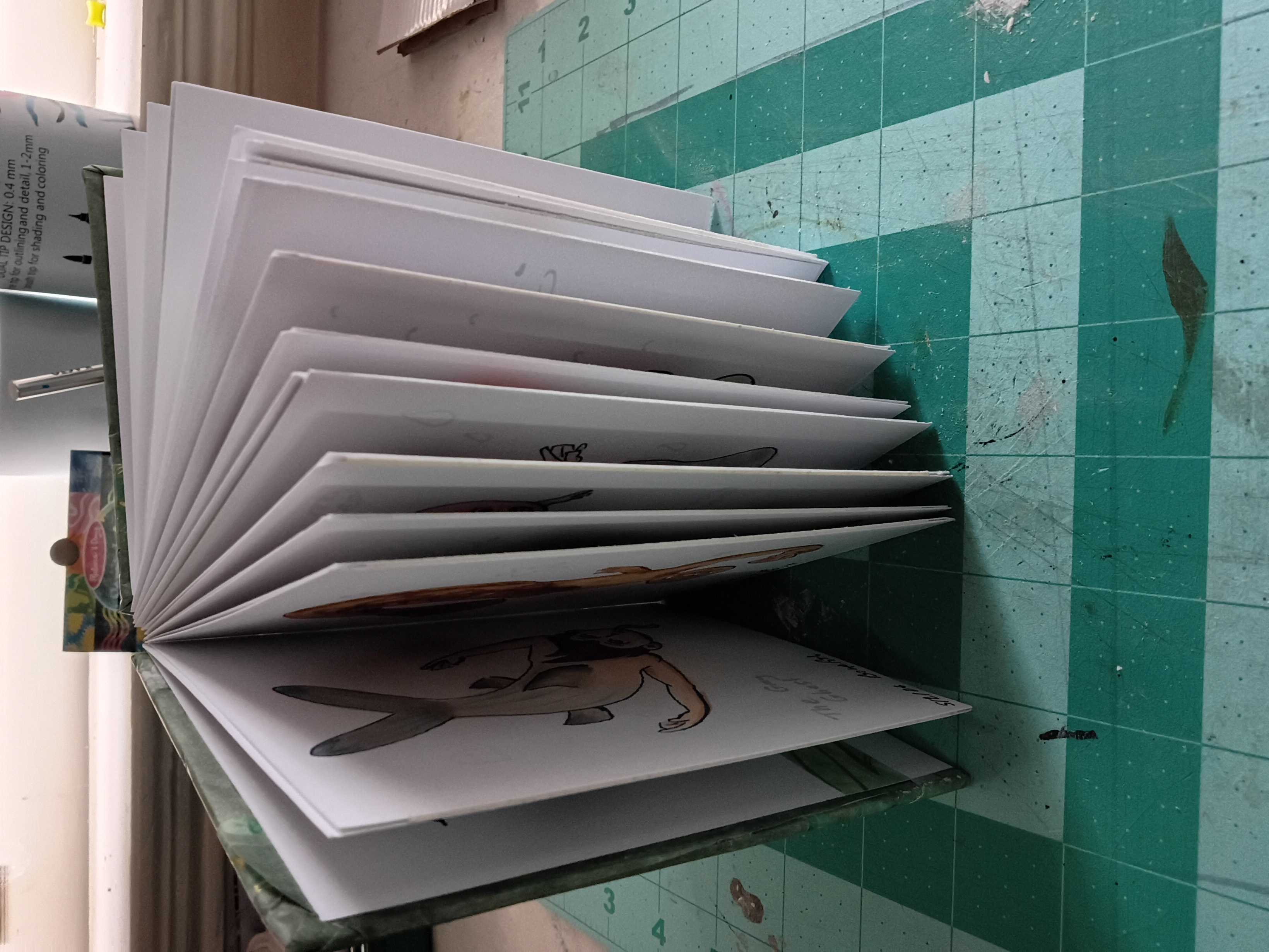 A crafted book with the pages fanned out sitting upright on a table